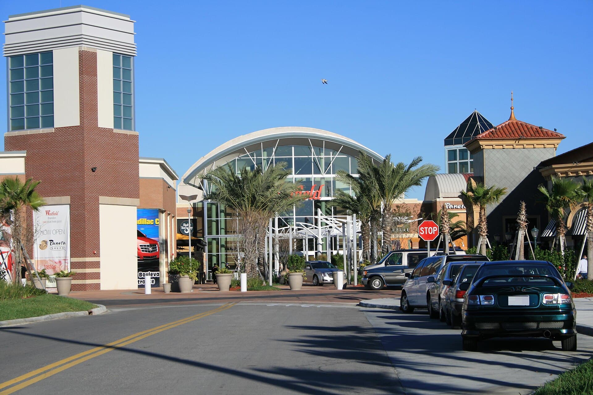 The palm-lined entrance of Westfield Brandon mall under a blue sky